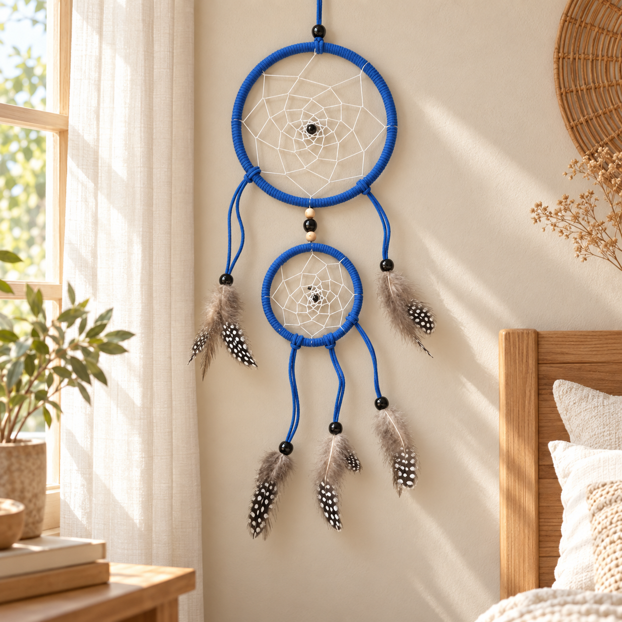 Calm Is Your Power Blue Double-Hoop Dreamcatcher hanging on a bedroom wall