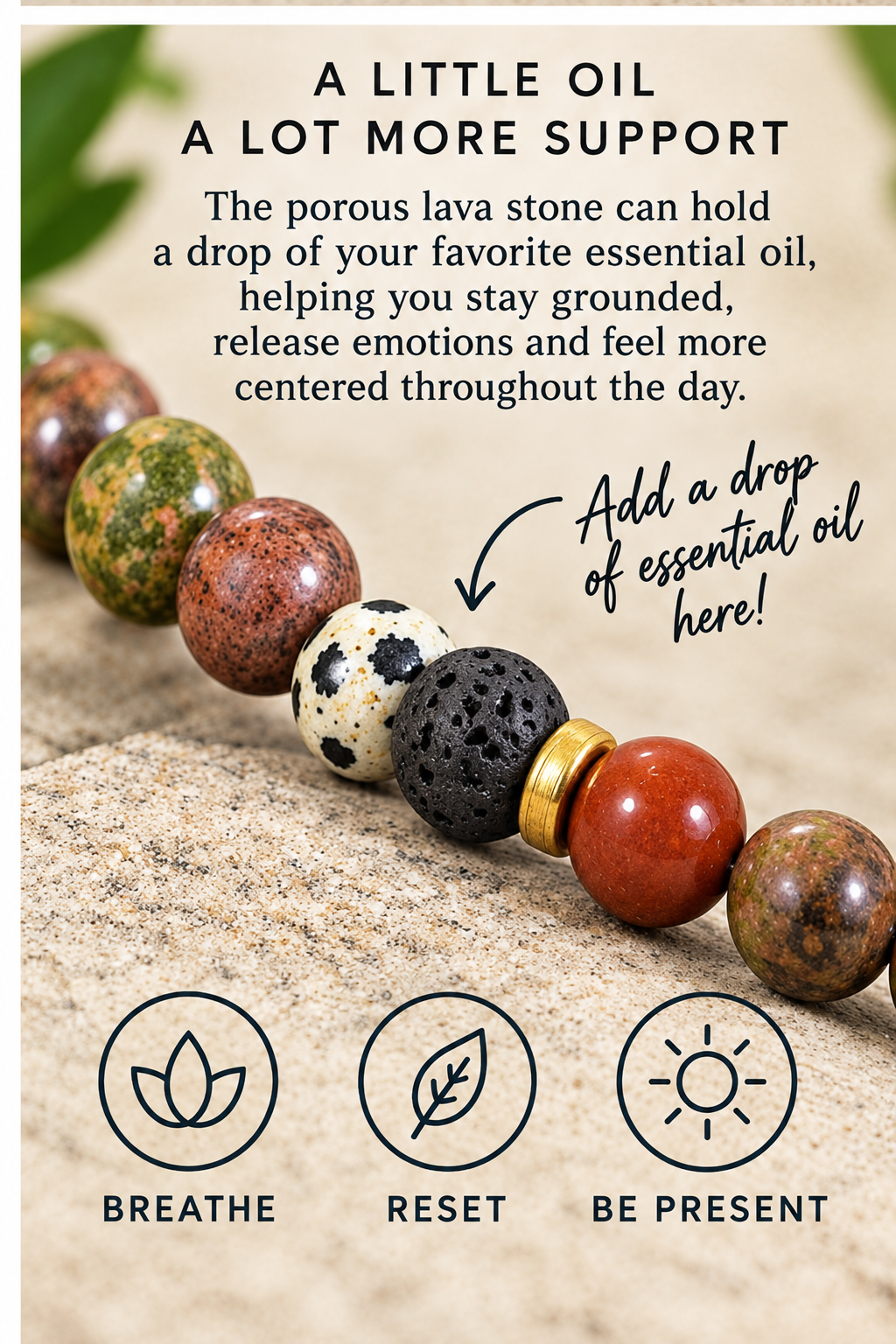 A beaded stone bracelet or necklace with polished and porous lava stones in earthy brown, cream, black, and red tones, shown on a textured stone surface with text about essential oil support and three circular icons labeled BREATHE, RESET, and BE PRESENT.