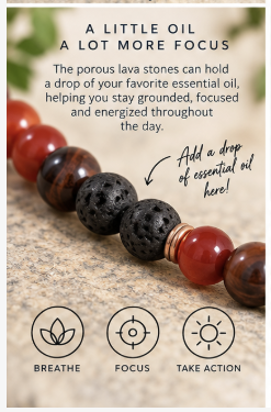 A close-up of a beaded strand with red translucent stones, dark porous black lava stones, and a few brown wood beads on a beige surface. Text above reads 'A LITTLE OIL A LOT MORE FOCUS' with an arrow pointing to the beads, and three icons below labeled BREATHE, FOCUS, and TAKE ACTION.
