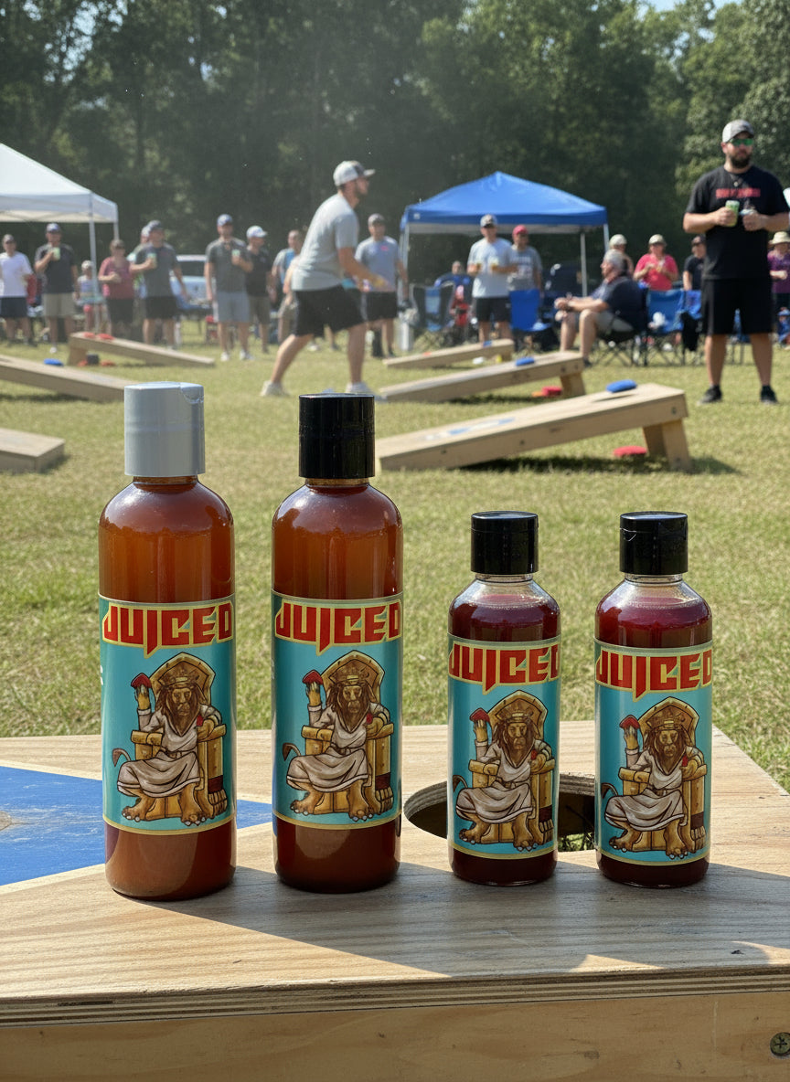 Four bottles of a product with colorful labels on a dark background