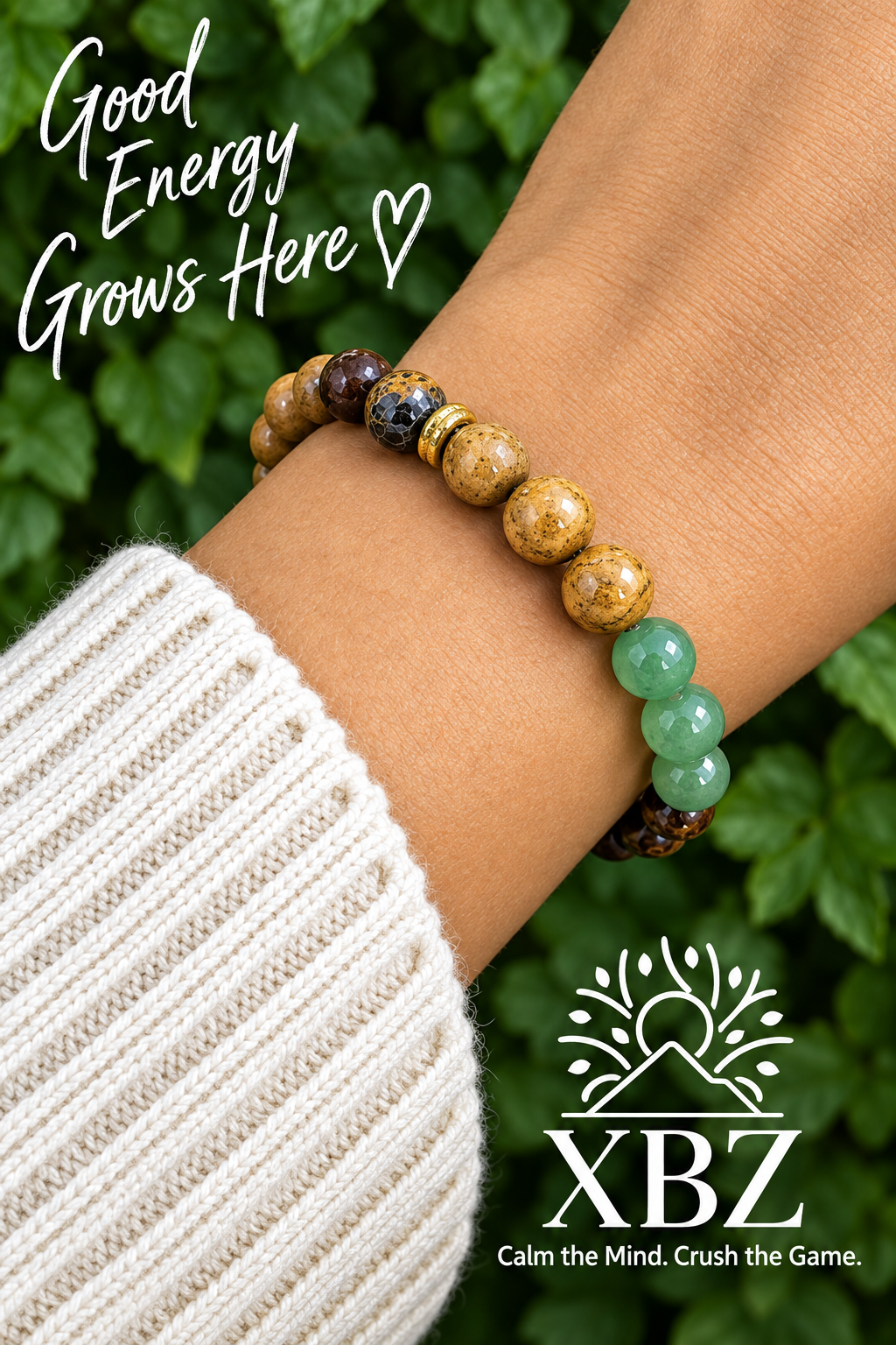 A close-up of a person's wrist wearing a beaded bracelet with natural wood, dark brown, and light green beads, styled with a white ribbed sweater against a blurred green background. Text overlays read 'Good Energy Grows Here' and 'XBZ'.