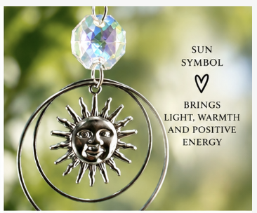 closeup of sun ornament on rainbow suncatcher sun symbol with crystal bead brings light, warmth and positive energy