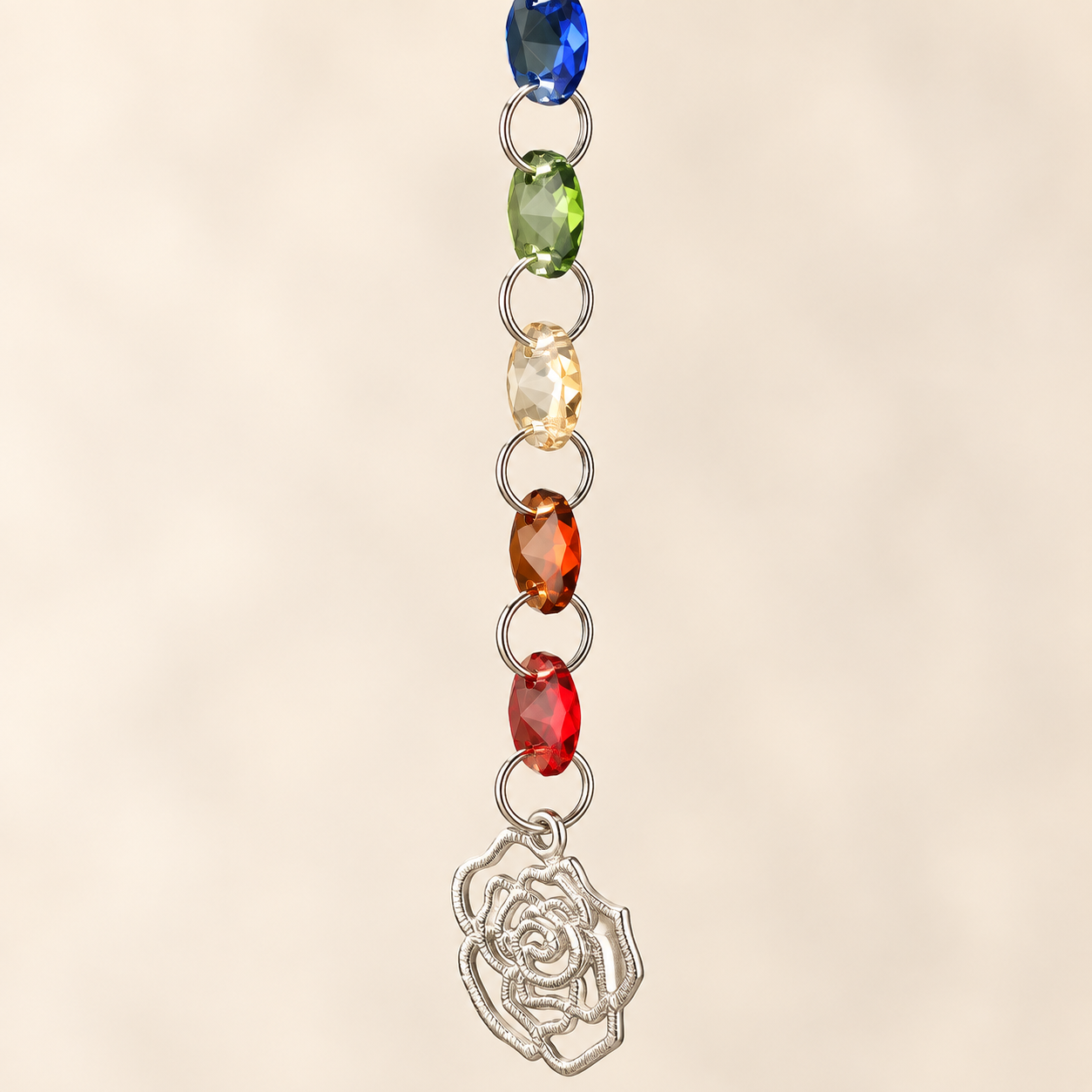 Rainbow Crystal Rose Suncatcher hanging in a white background