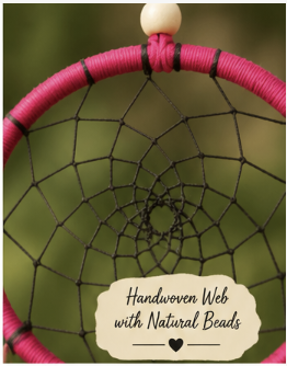A close-up of a handwoven dreamcatcher with a bright pink wrapped hoop, black webbing, and natural beige beads, set against a blurred green outdoor background with a text overlay.