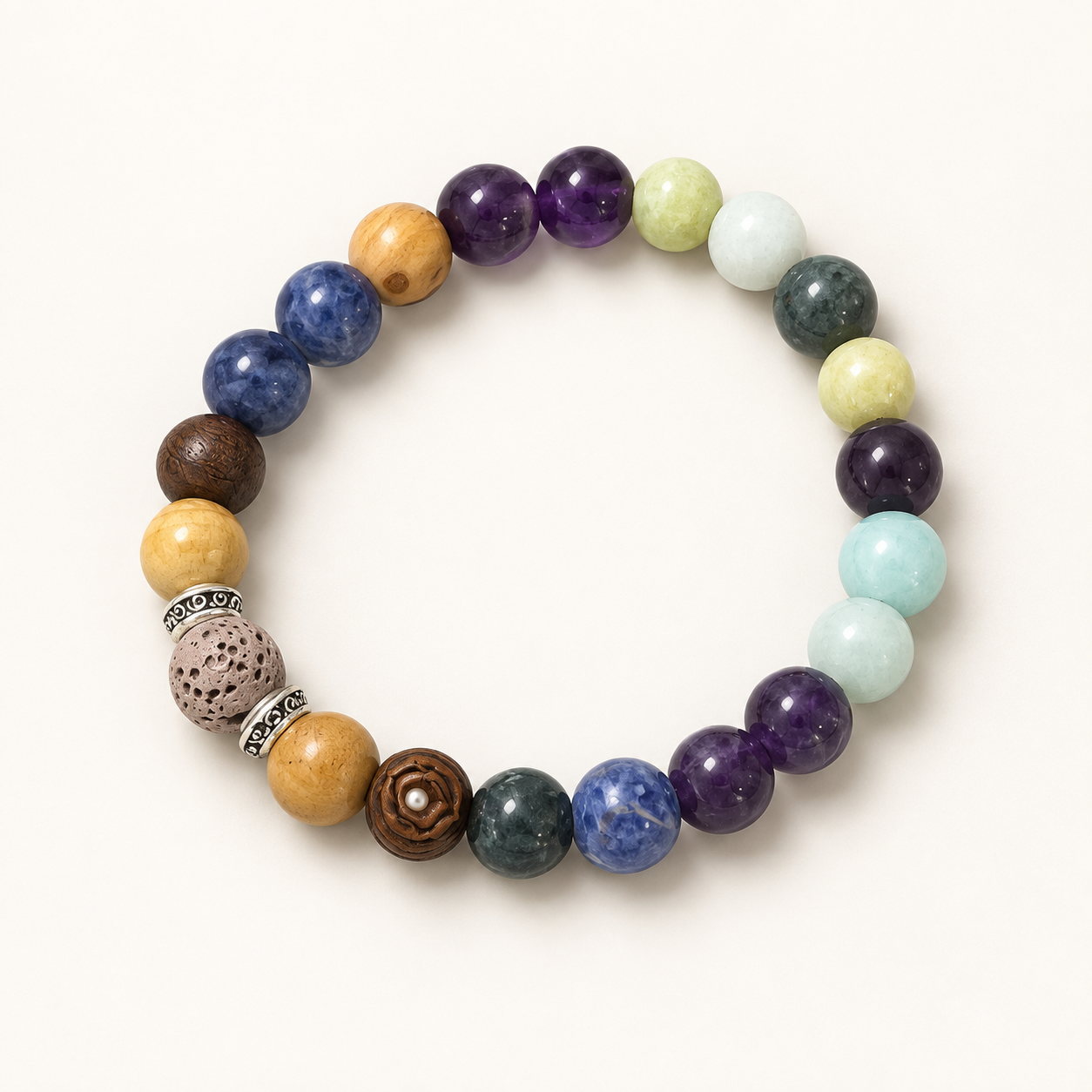 A beaded stretch bracelet featuring a variety of polished gemstone and wood beads in purple, blue, green, yellow, brown, and white, arranged in a circular pattern on a light cream background.