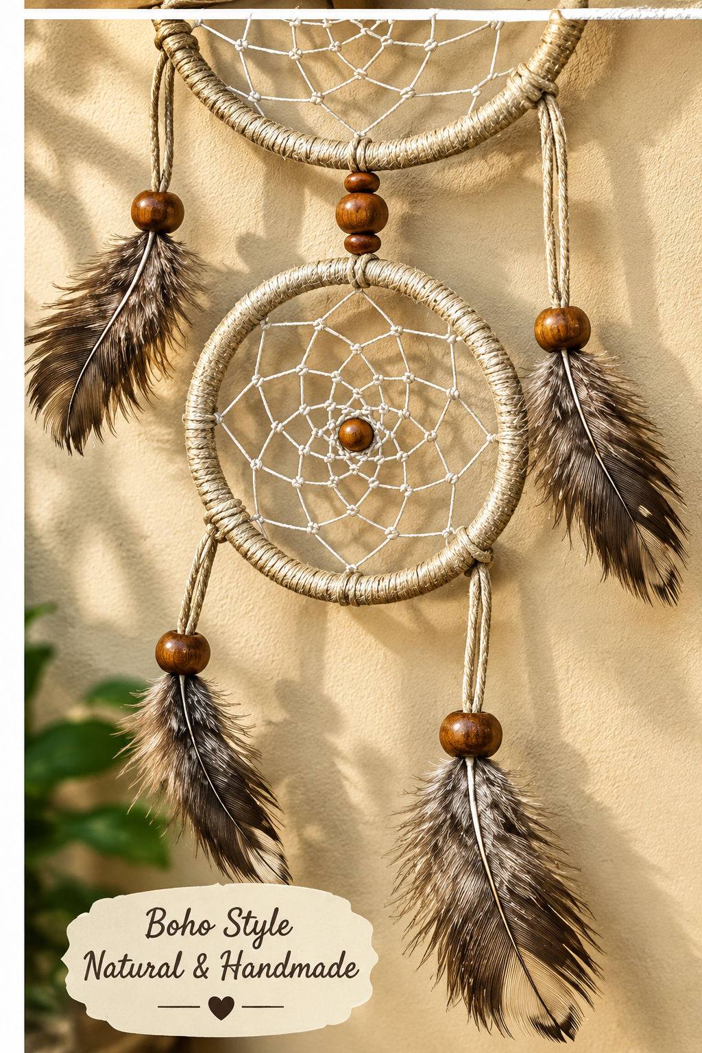 Two boho-style dreamcatchers hanging on a beige wall, featuring natural woven webbing, brown wooden beads, and brown feathers. A label at the bottom reads 'Boho Style Natural & Handmade'.