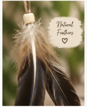 A close-up of a hanging feather ornament or tassel with a cream bead, fluffy white and tan feathers, and one long dark brown feather with fine black and golden barbs. A handwritten note in the upper right reads 'Natural Feathers'.